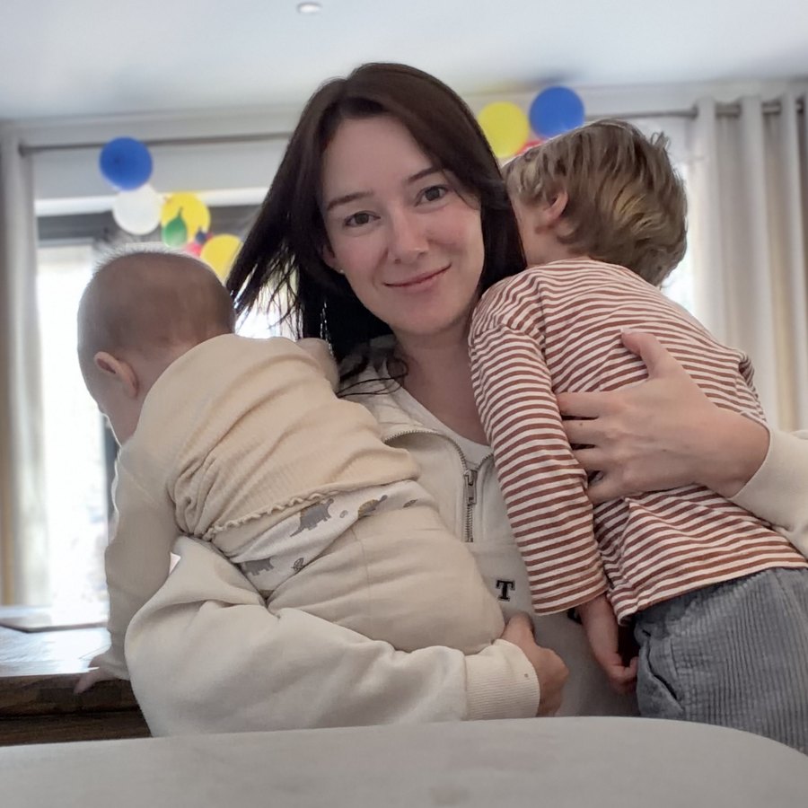 Olivia at home, holding two little ones